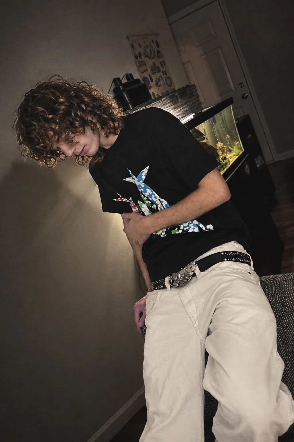 TECAY creator wearing his own handmade white double-waisted jeans