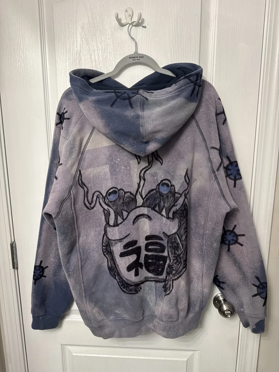 Original hand-drawn artwork on a washed hoodie by TECAY