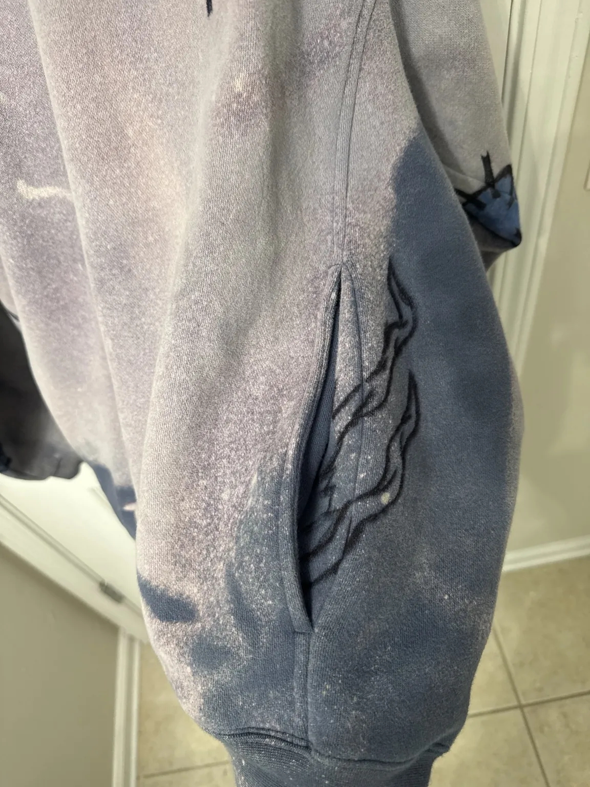 Hand-drawn sigil artwork on washed hoodie fabric