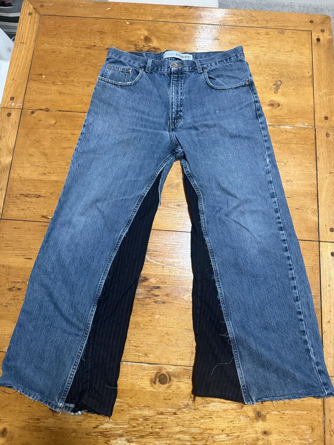 Blue denim jeans widened with dark pinstripe material