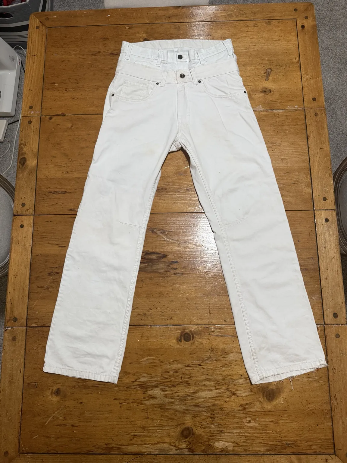 White double-waisted jeans laid flat, front view
